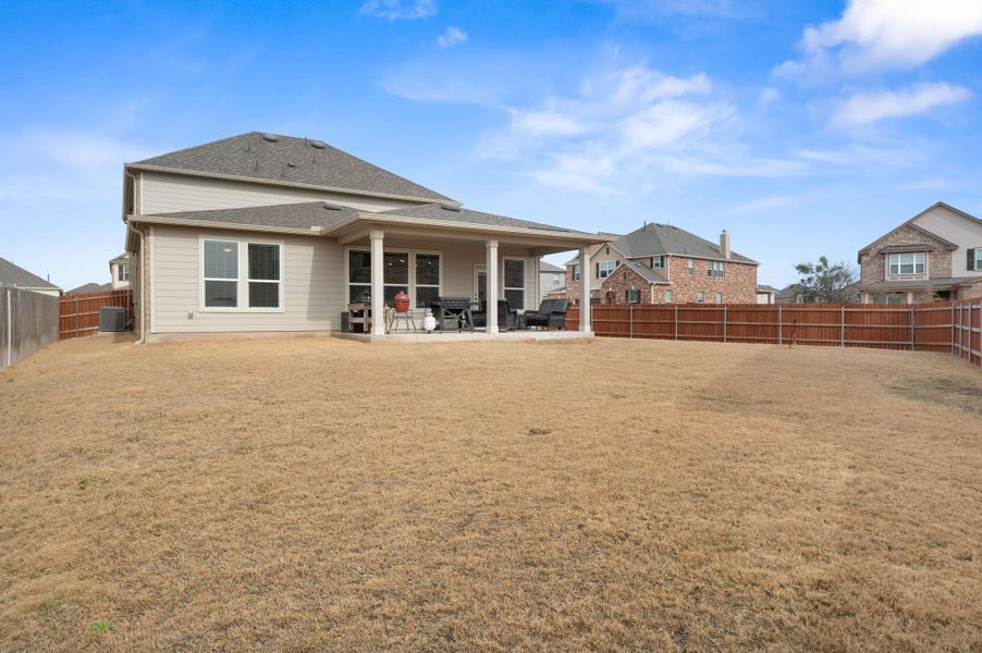 Rear view of property featuring a patio area and a fenced backyard