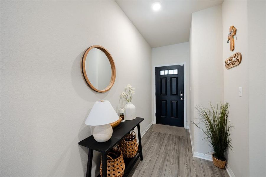 Foyer featuring baseboards and light wood finished floors
