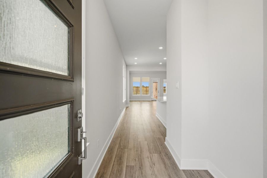 Bright foyer featuring luxury vinyl plank flooring and Hunter Douglas blinds throughout. Bright foyer featuring luxury vinyl plank flooring and Hunter Douglas blinds throughout.