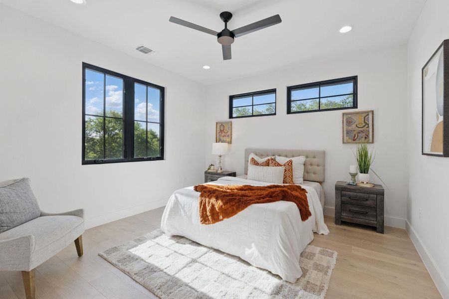 Bedroom with light wood-style floors, recessed lighting, and a ceiling fan