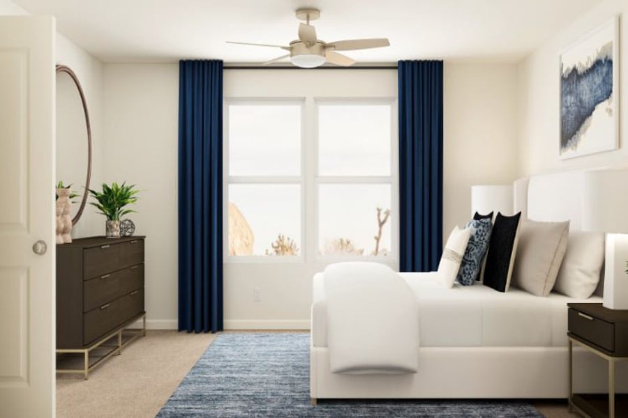 A living room with a white couch and a fan.
