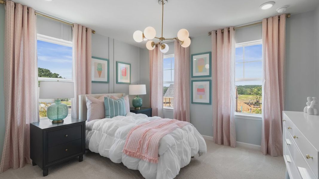 Kids bedroom with soft color scheme and many windows in new construction townhome.