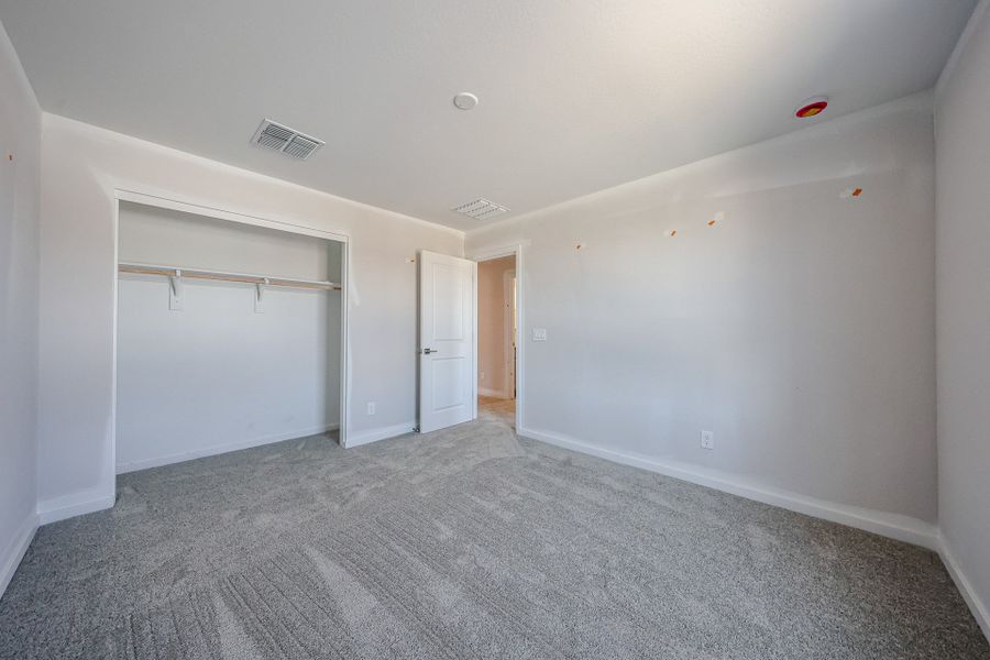 A room with a carpet and a door. A room with a carpet and a door.