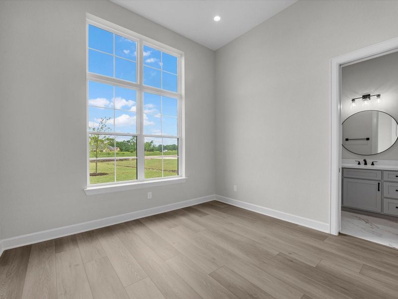 Light-filled secondary bedroom with neutral tones and modern finishes.