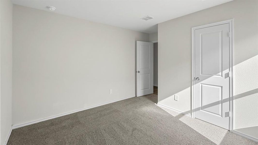 Unfurnished bedroom featuring carpet flooring and baseboards
