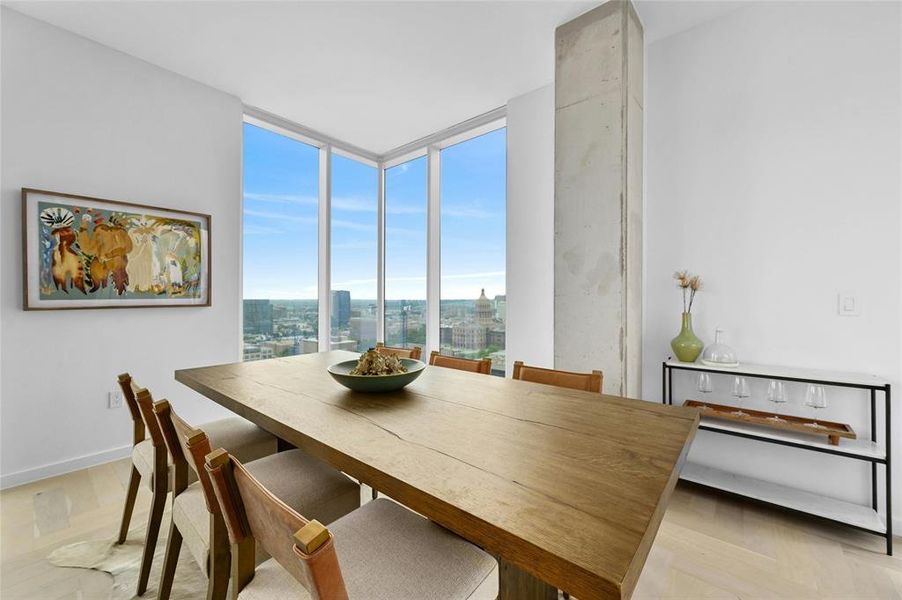 The dining area offers a perfect setting to enjoy meals while soaking in the breathtaking panoramic city view. *Linden Residence No. 2107 Furnished Model Shown Here