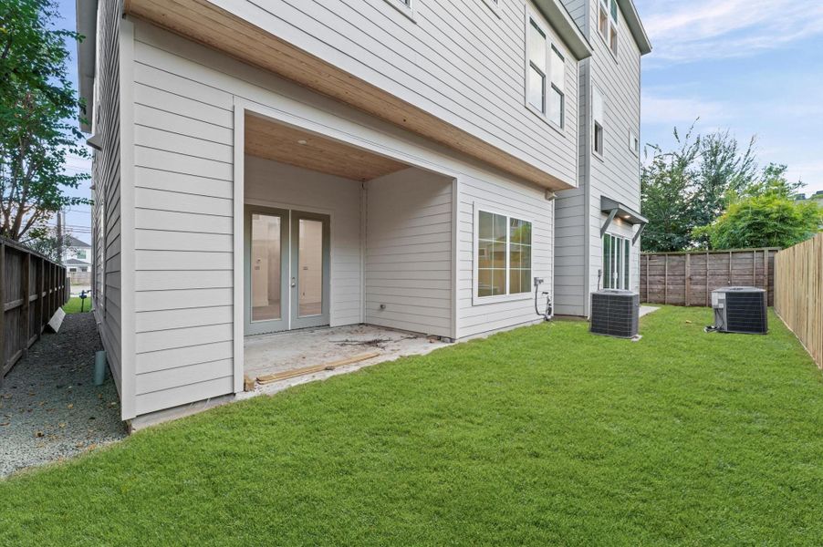 Covered patio leads to the welcoming backyard.