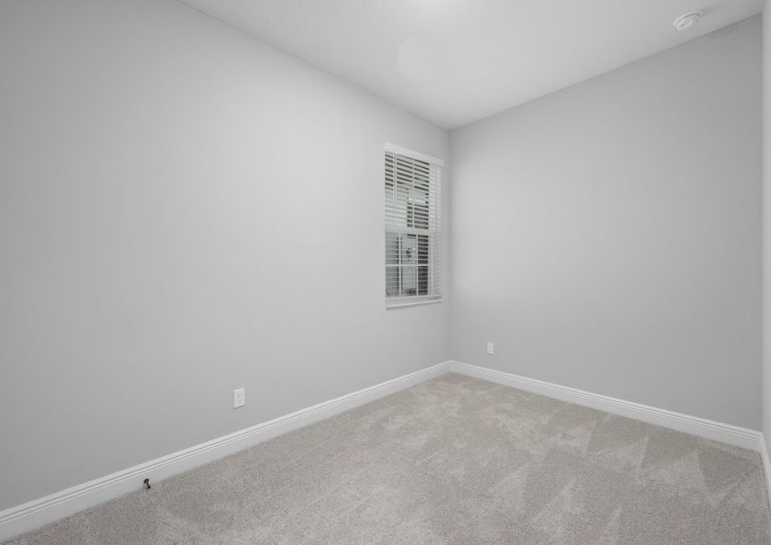 Bedroom with carpet flooring and a window with faux wood blinds
