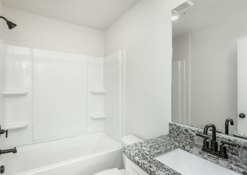 The secondary bathroom has a large soaking tub.