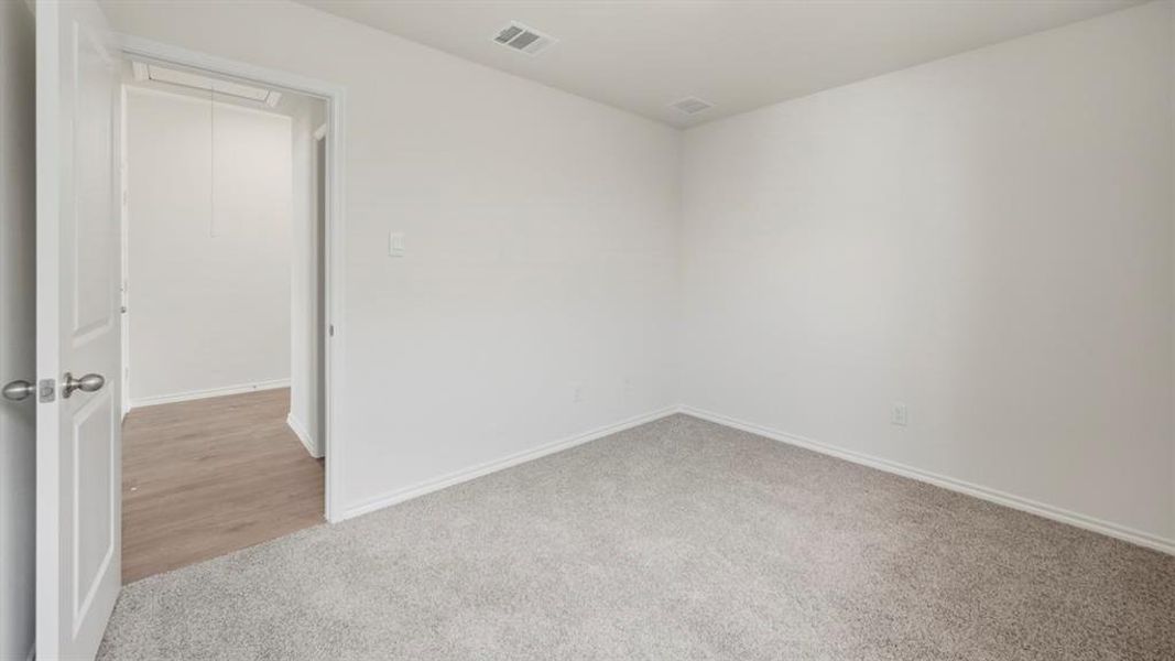 Unfurnished room with light carpet and baseboards