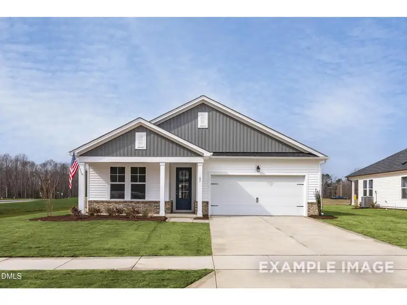 Front exterior of a new home in Retreat at North Main, Lillington, NC, highlighting curb appeal (Image 1). Front exterior of a new home in Retreat at North Main, Lillington, NC, highlighting curb appeal (Image 1).