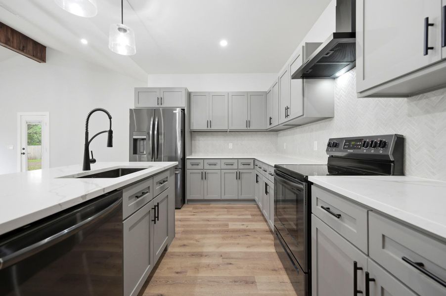 A well-appointed kitchen showcasing contemporary cabinetry, sleek countertops, and essential modern appliances. A well-appointed kitchen showcasing contemporary cabinetry, sleek countertops, and essential modern appliances.