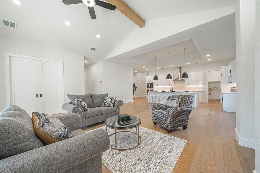 Living room with light wood-style floors, recessed lighting, and a ceiling fan