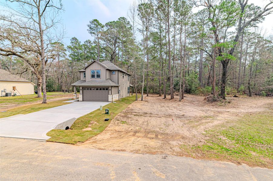 Front exterior of a new home in , Huntsville, TX, highlighting curb appeal (Image 26).