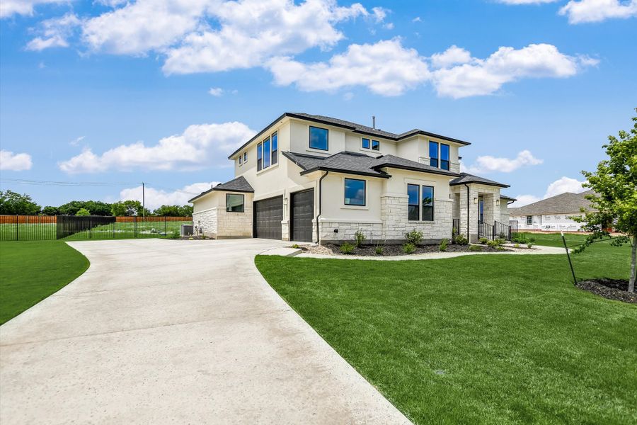 Front exterior of a new home in Scofield Farms Estates, Georgetown, TX, highlighting curb appeal (Image 22).