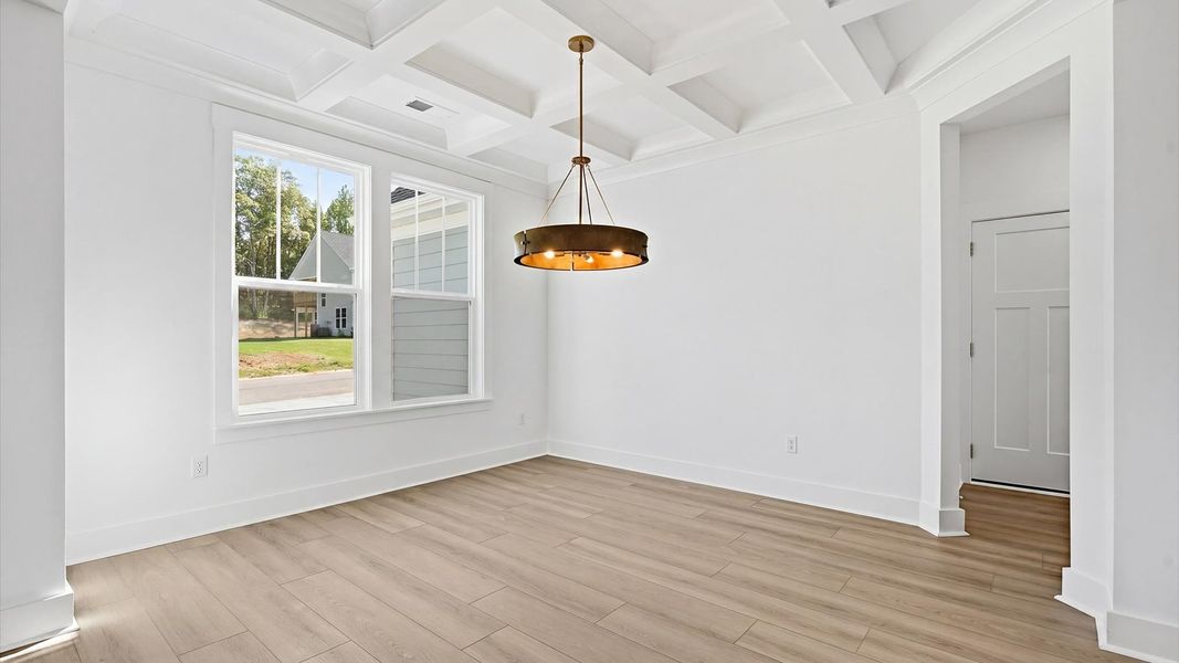 Coffered ceiling detail brings depth and sophistication to this top-notch formal dining room