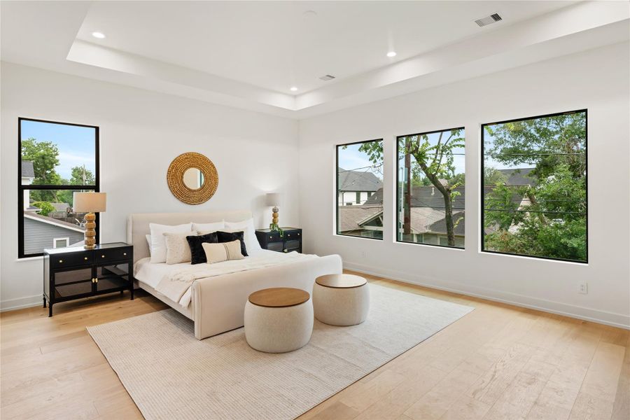 Expansive primary bedroom suite creates a serene sanctuary with huge windows that flood the space with natural light. This generously proportioned master retreat provides the perfect escape for rest and relaxation in luxurious comfort.