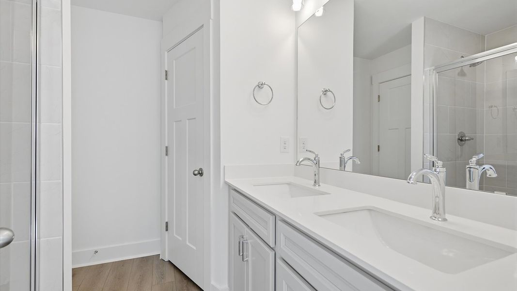 Spacious and modern primary bathroom with walk-in shower and first-class double vanity setup near Simpsonville, SC