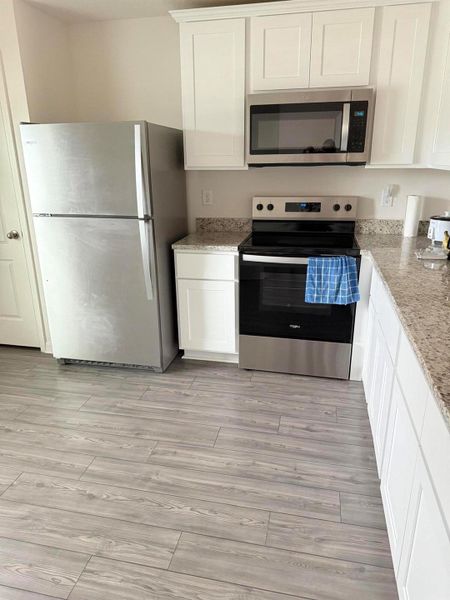 Furnished interior view inside a new home in , Port St. Lucie (Image 2).