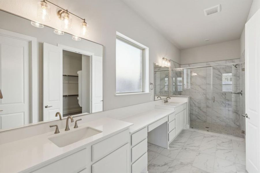 Bathroom featuring vanity and a shower with shower door