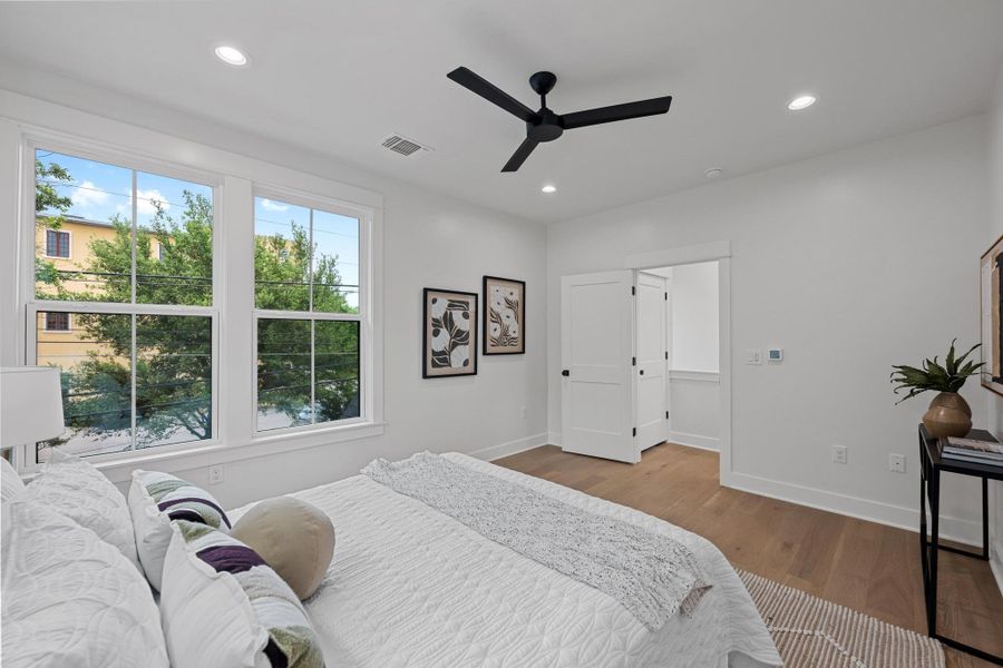 Bedroom with visible vents, recessed lighting, and wood finished floors