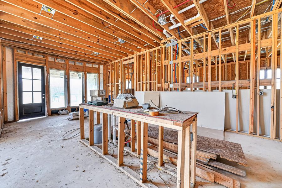 Open unfinished space showcasing framing and build progress.