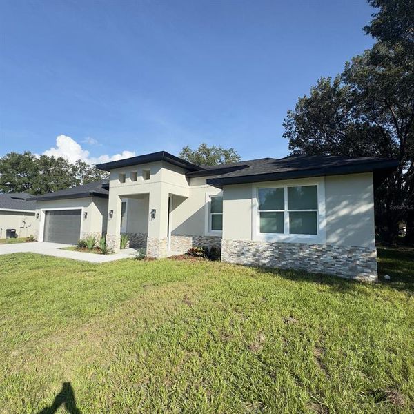 Front exterior of a new home in , Ocala, FL, highlighting curb appeal (Image 1).