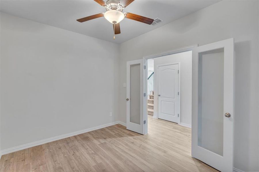 Spare room featuring light hardwood / wood-style floors and ceiling fan