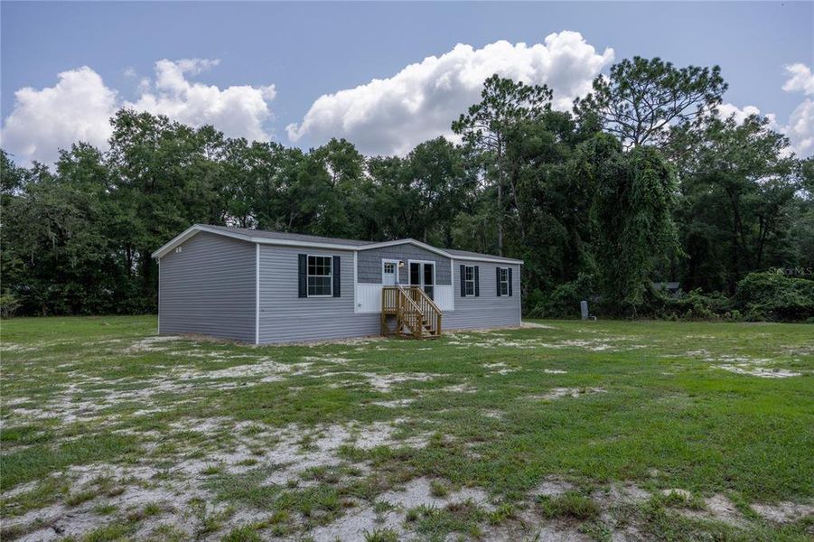 Front exterior of a new home in , Fort White, FL, highlighting curb appeal (Image 24).