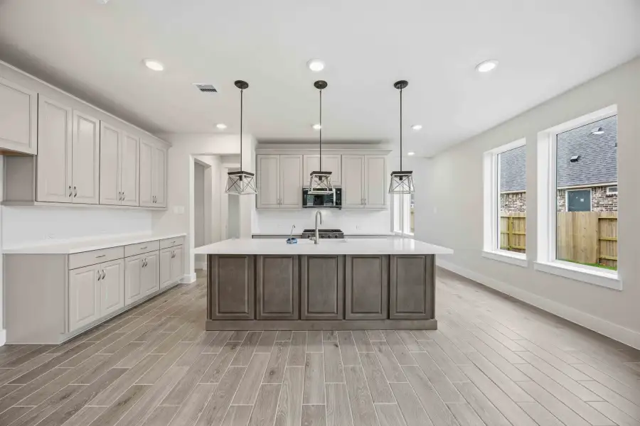 Furnished interior view inside a new home in Ellwood, Iowa Colony (Image 10).