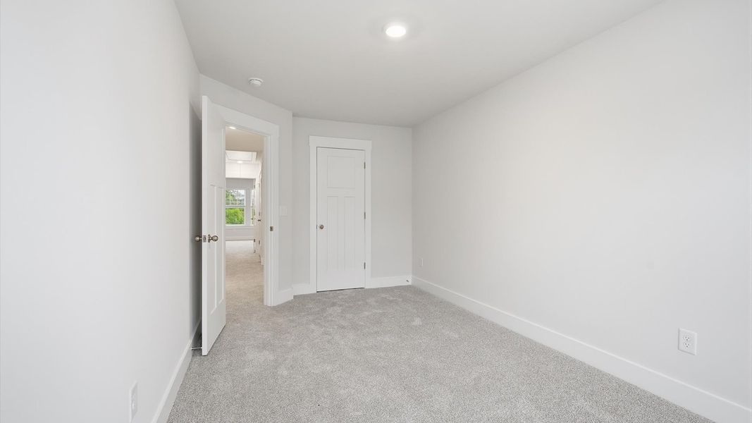 Notable secondary bedroom offering cozy carpeted flooring and a stylish walk-in closet located in Lyman, SC