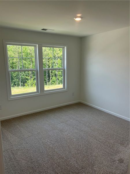 Plush carpet and bright windows offer a tranquil r