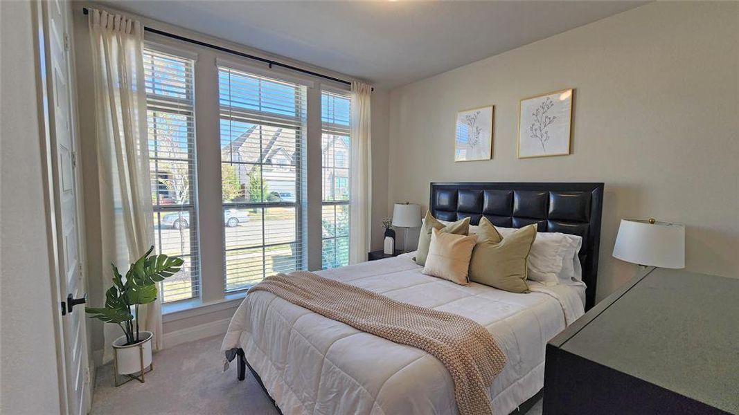 Bedroom featuring carpet and baseboards