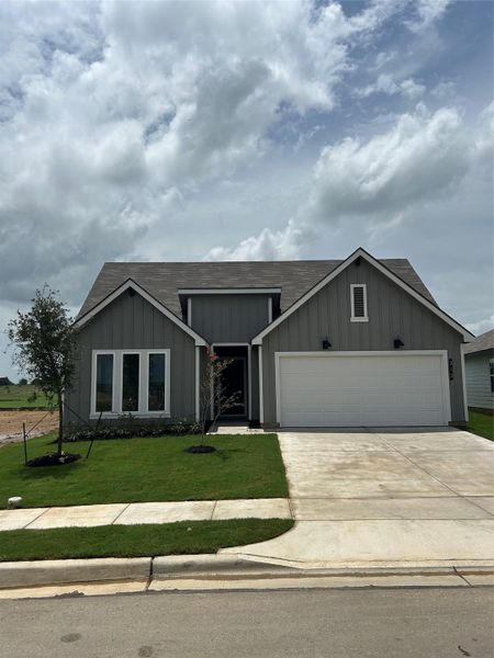 Front exterior of a new home in Cornerstone, Rockdale, TX, highlighting curb appeal (Image 1).