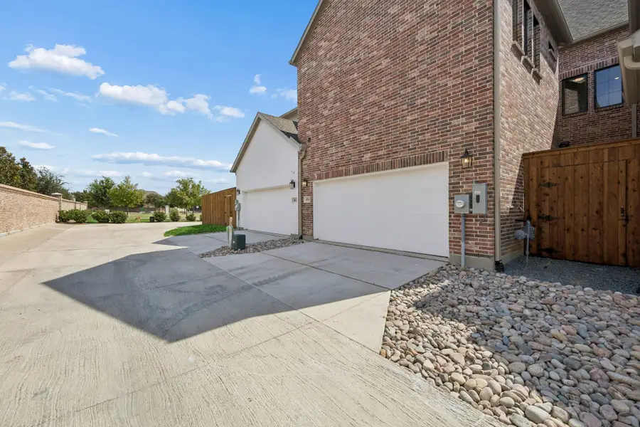Exterior details and patio area of a home in Newman Village Townhomes, Frisco (Image 20).