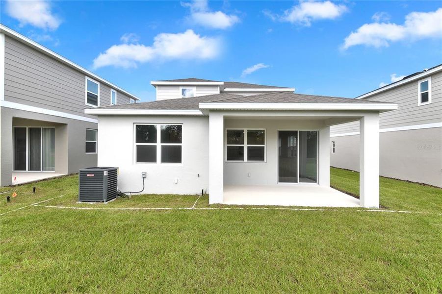 Front exterior of a new home in Seasons at Shores of Lake Dell, Dundee, FL, highlighting curb appeal (Image 2).