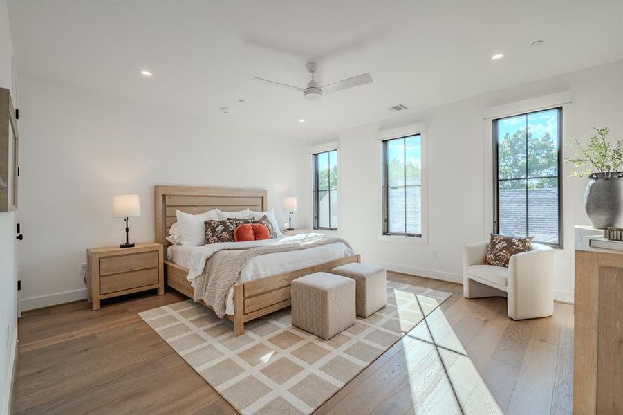 Bedroom featuring recessed lighting, light wood-type flooring, and a ceiling fan Bedroom featuring recessed lighting, light wood-type flooring, and a ceiling fan