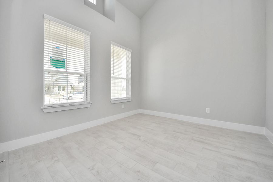 Step into the inviting home office, where elegant tile flooring adds a touch of freshness and comfort to the workspace. Natural light pours through the window, creating an inspiring environment for productivity and focus.