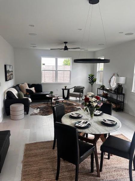 Dining space with healthy amount of natural light and a ceiling fan