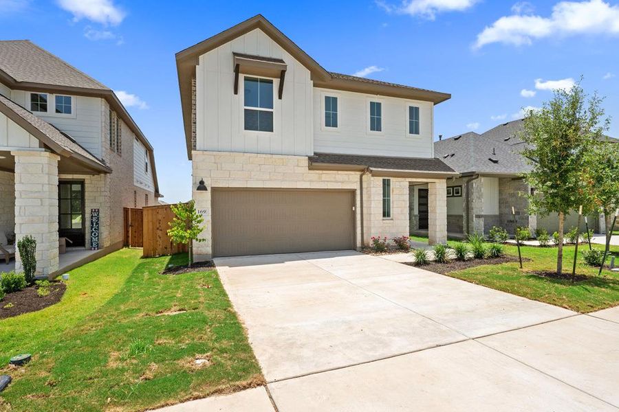 Front exterior of a new home in Heritage, Dripping Springs, TX, highlighting curb appeal (Image 2). Front exterior of a new home in Heritage, Dripping Springs, TX, highlighting curb appeal (Image 2).