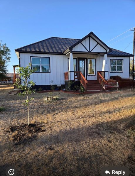 View of front of house featuring a standing seam roof, a metal roof, and board and batten siding
