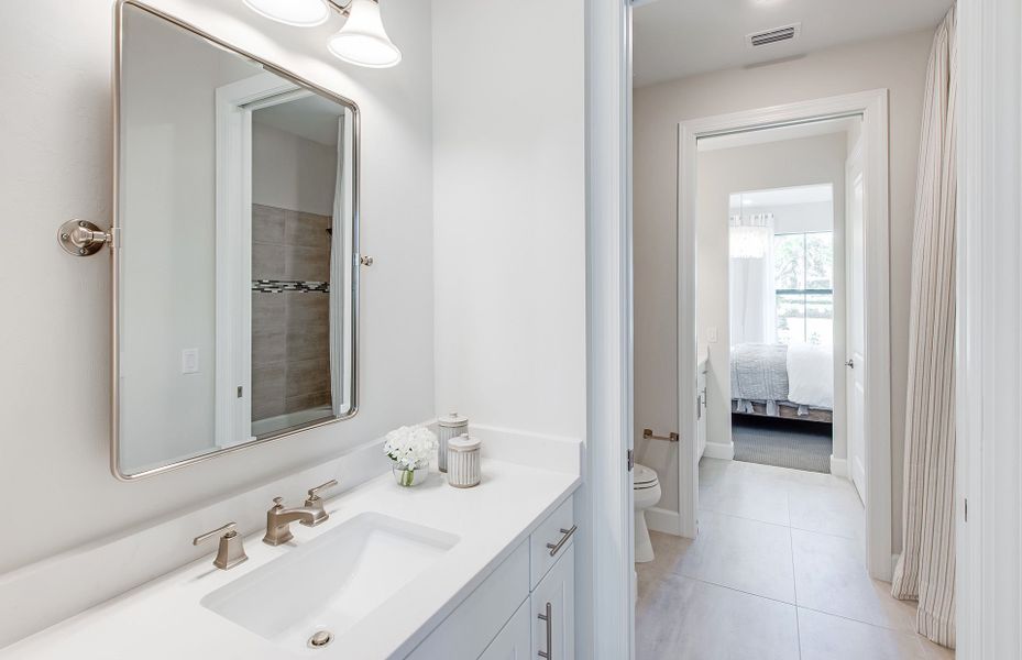 Jack and Jill style bathroom with private sinks