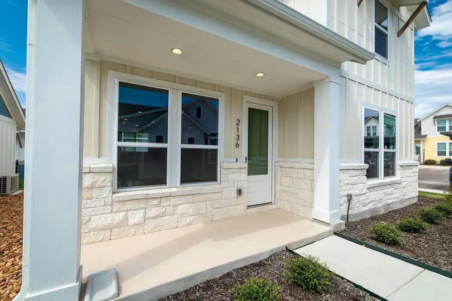 Welcoming front porch entry highlights the attractive stone and board-and-batten exterior design. Welcoming front porch entry highlights the attractive stone and board-and-batten exterior design.