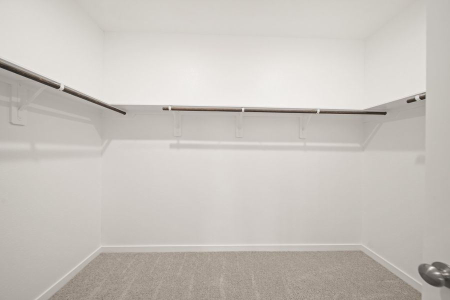 A white wall with a metal bar.