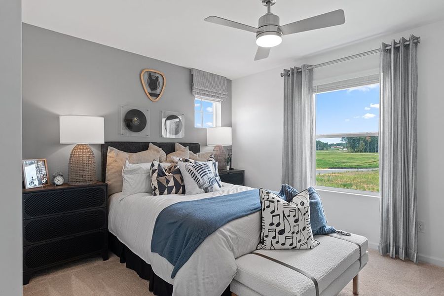 A bedroom with a large window.