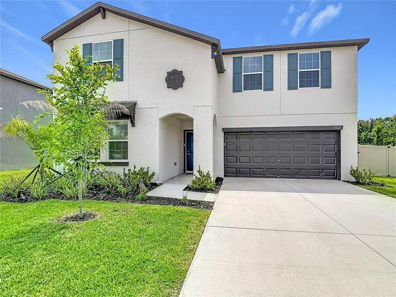 Front exterior of a new home in , Lakeland, FL, highlighting curb appeal (Image 27).