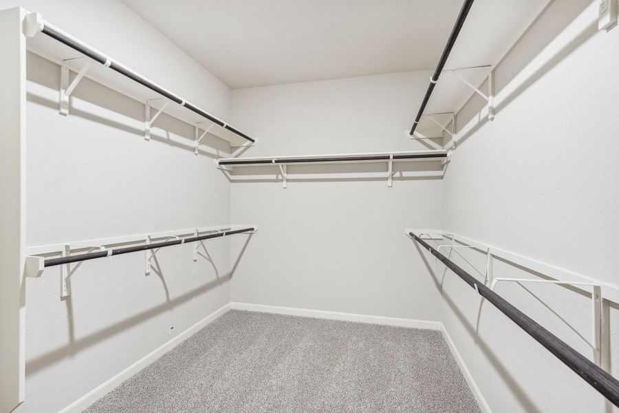 Primary suite walk-in closet in the Fitzhugh floorplan at a Meritage homes community.