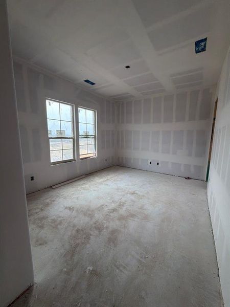 Spare room with unfinished concrete flooring Spare room with unfinished concrete flooring
