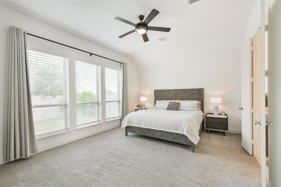 Generous primary suite with a wall of windows looking to the private backyard. Generous primary suite with a wall of windows looking to the private backyard.