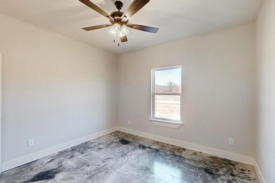 Spare room featuring baseboards and a ceiling fan